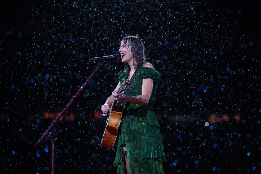 Taylor Swift exudes joy as she takes the stage amidst a torrential downpour