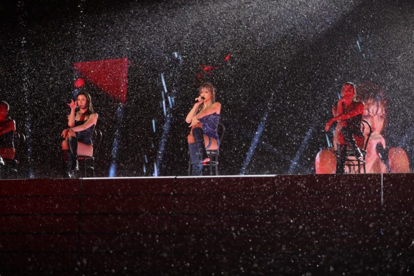 Taylor Swift exudes joy as she takes the stage amidst a torrential downpour