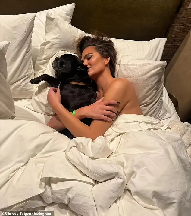 Chrissy Teigen Goes Topless and Cuddles Her Dog Penny