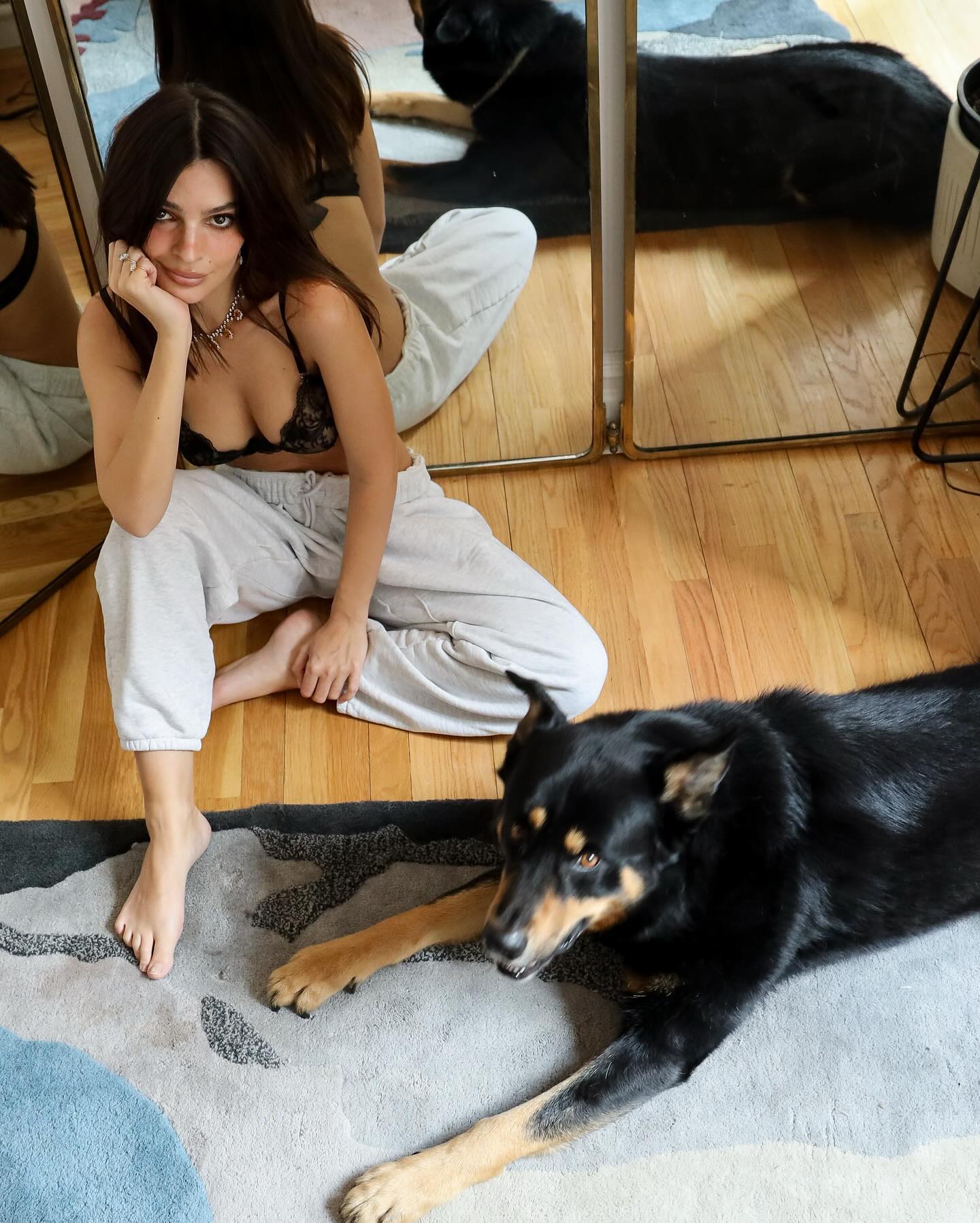 Emily Ratajkowski shared pictures from home wearing black bra and chilling with her dog